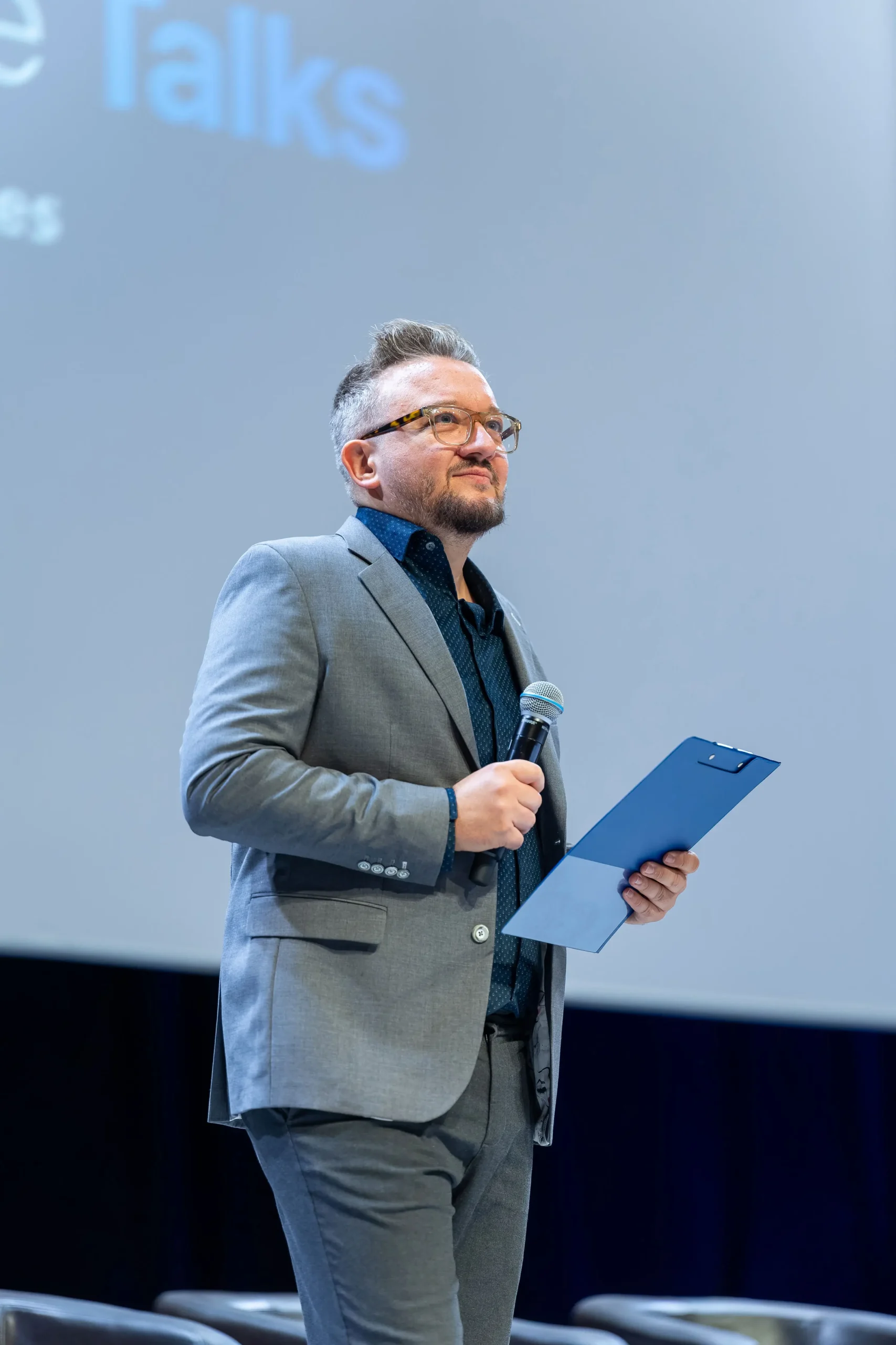 Florin Grozea delivering a talk to attendees seated in a conference hall
